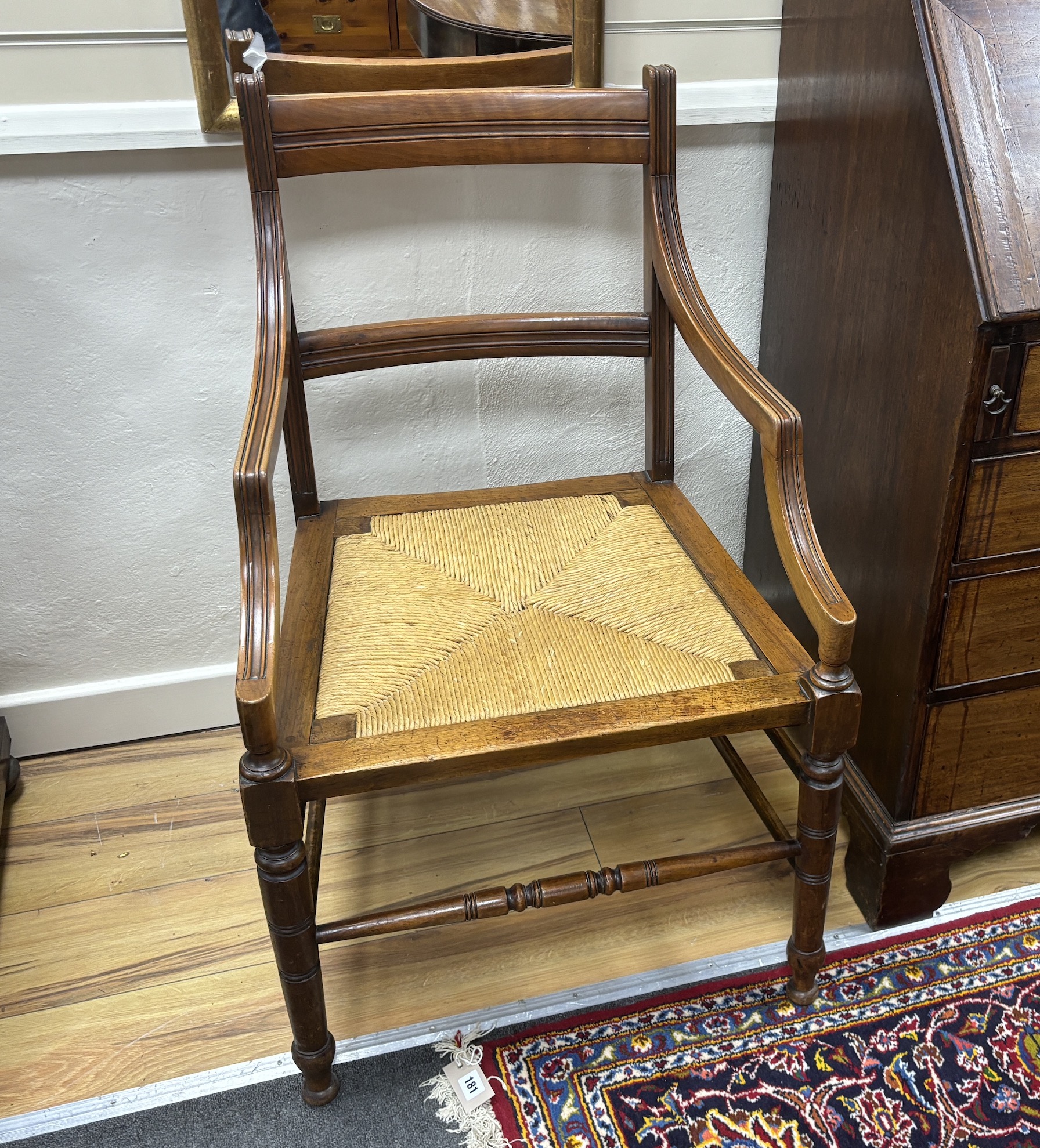 A pair of late Victorian Arts & Crafts mahogany rush seat elbow chairs, width 53cm, depth 49cm, height 94cm